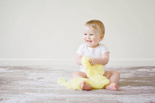 Free Toddler Sitting While Smiling Stock Photo