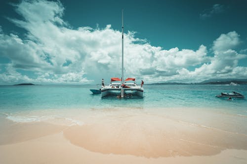 Free A Sailboat on the Beach Shore Stock Photo