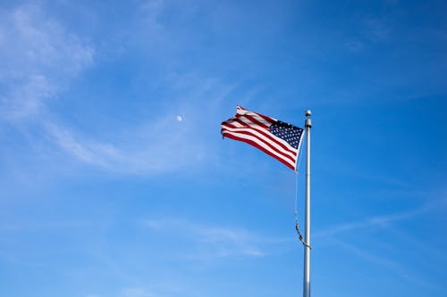 The Unite States Flag Swaying on a Flag Pole