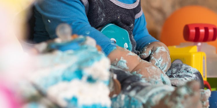 Faceless Child Playing With Whipped Cream