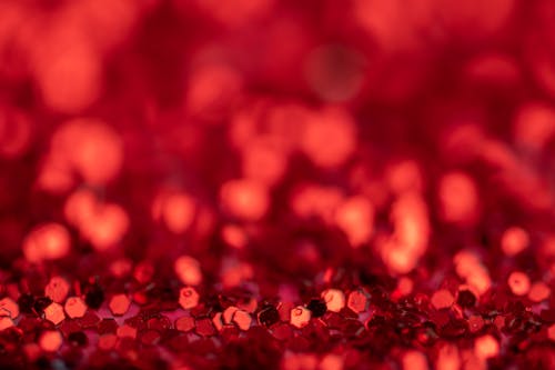 Free Soft focus background of bright red shiny small sequins for decoration spread on surface Stock Photo