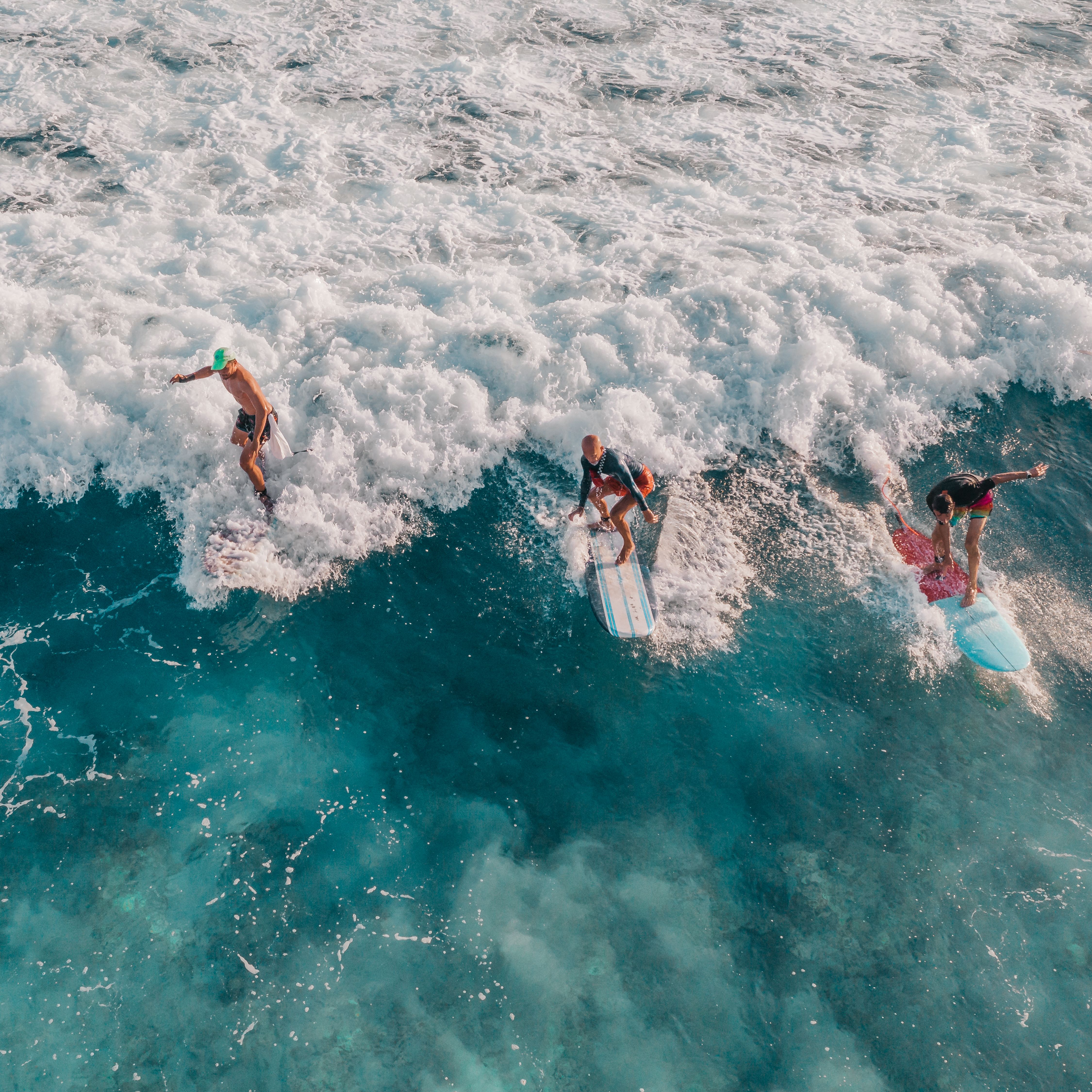 Aerial view of surfers catching waves in Tamarindo, Costa Rica