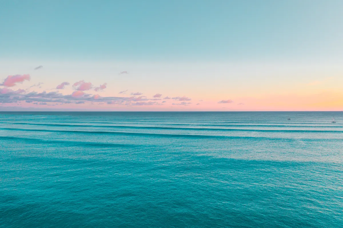 Pastel sunset over calm Hawaiian ocean water on Oahu's west side