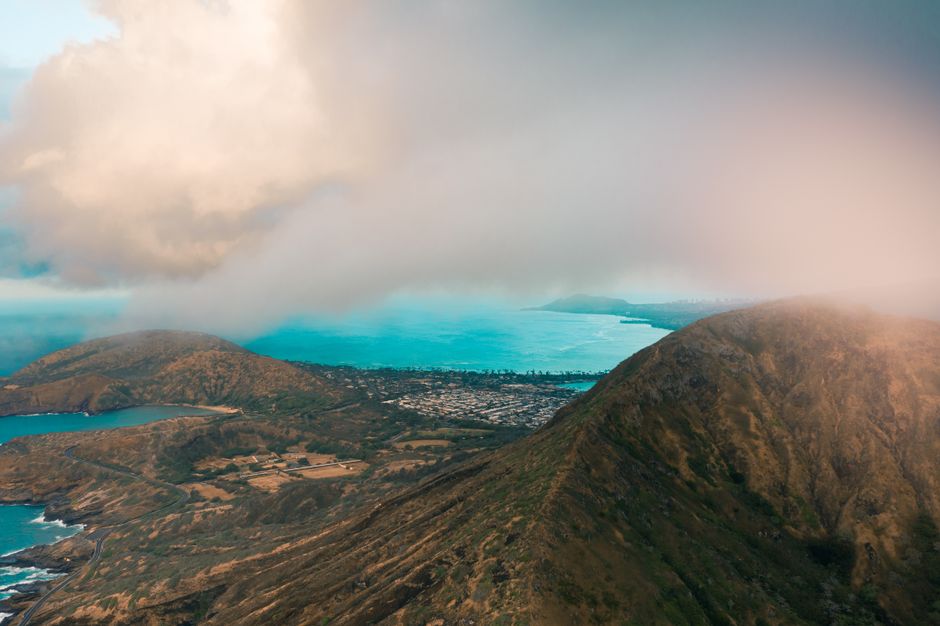 Best Kilauea Volcano Eruption 105 Min Helicopter Tour Doors Off or On Review Review 2026 - Stunning aerial view of Koko Head Crater and coastline in Honolulu, Hawaii, enveloped by clouds.