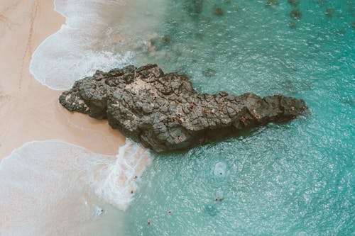 Brown Rock Formation on Body of Water