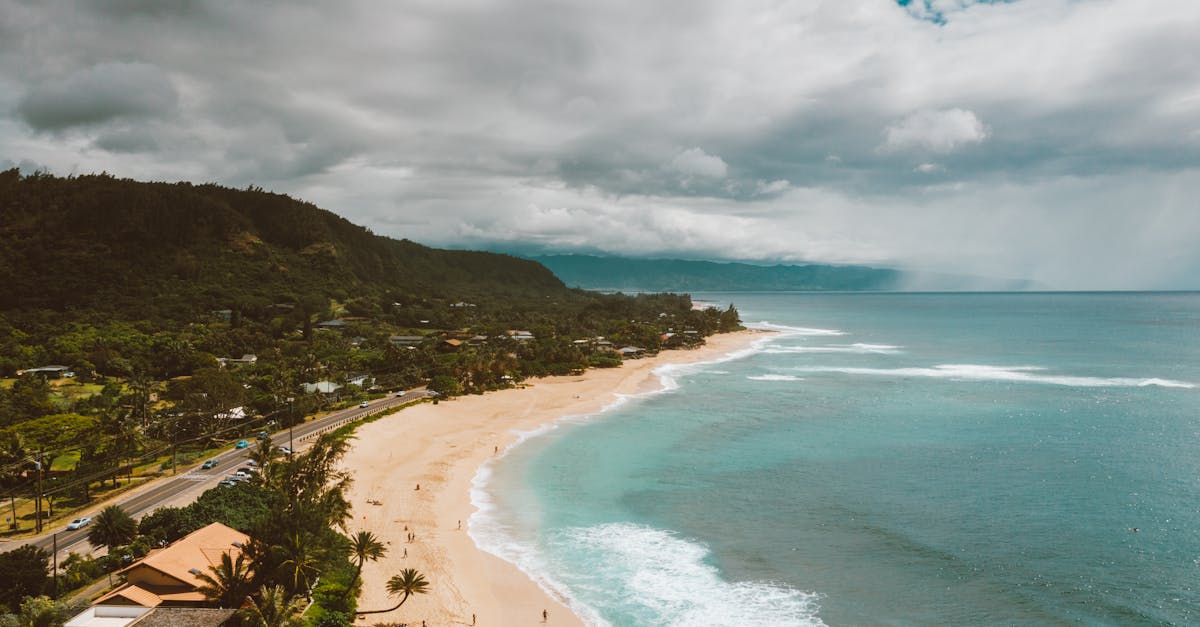 Photo by Jess Loiterton Stunning aerial shot of Pupukea Beach's turquoise waters and lush greenery in Hawaii.