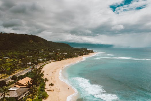 Stunning aerial shot of Pupukea Beach's turquoise waters and lush greenery in Hawaii.