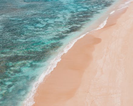 Beautiful aerial shot of the coastline at Pupukea Beach, Hawaii, showcasing sandy shores and turquoise waters.
