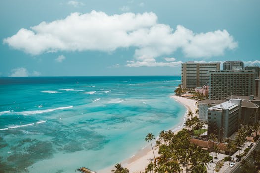 Stunning aerial view of Waikiki Beach and hotels in Honolulu, Hawaii, on a bright sunny day.