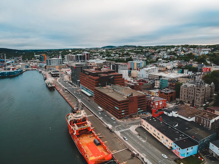 Ships On River In City Port Near Old Buildings