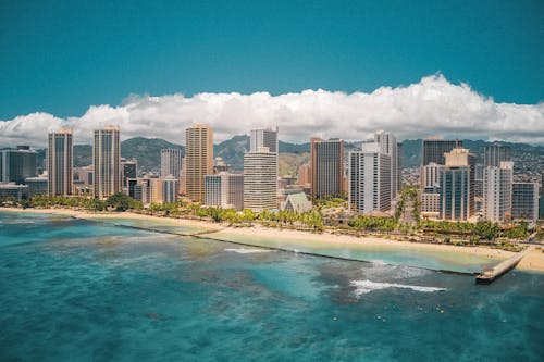 High Rise Buildings Near Sea Under Blue Sky