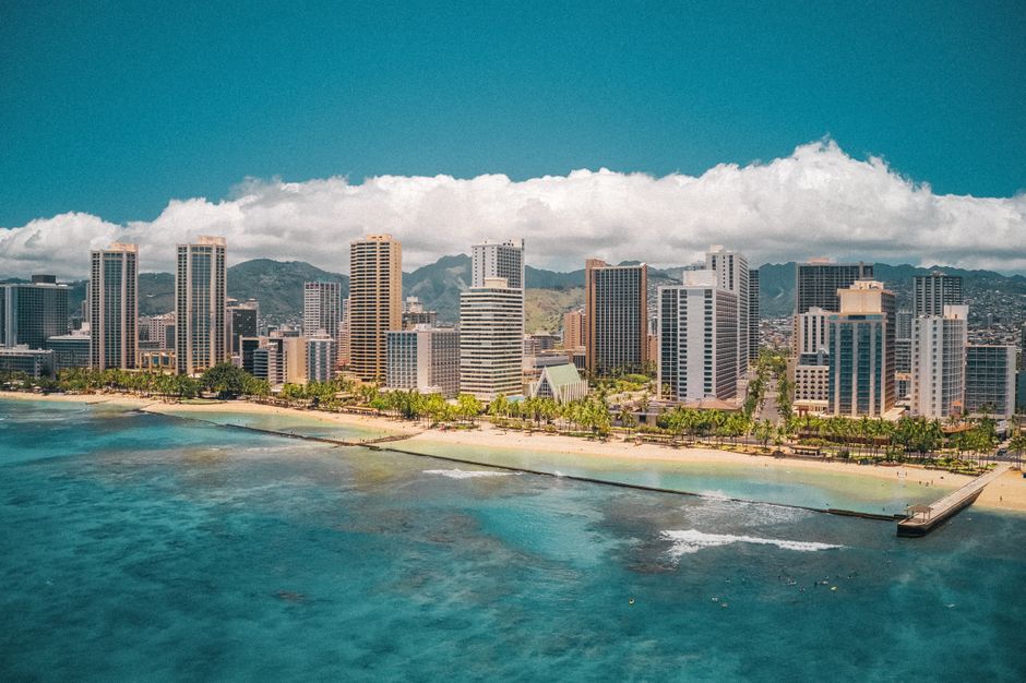 Oahu: 60 Min Royal Crown Helicopter Tour - Doors Off or On - Stunning aerial view of Waikiki Beach and cityscape under clear blue skies in Honolulu, Hawaii.