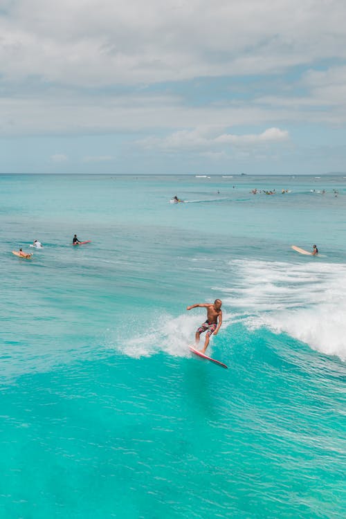 People Surfing on Sea Waves