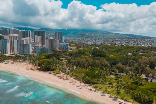 Free Stunning aerial view of Waikiki Beach with the skyscrapers of Honolulu in the backdrop. Stock Photo