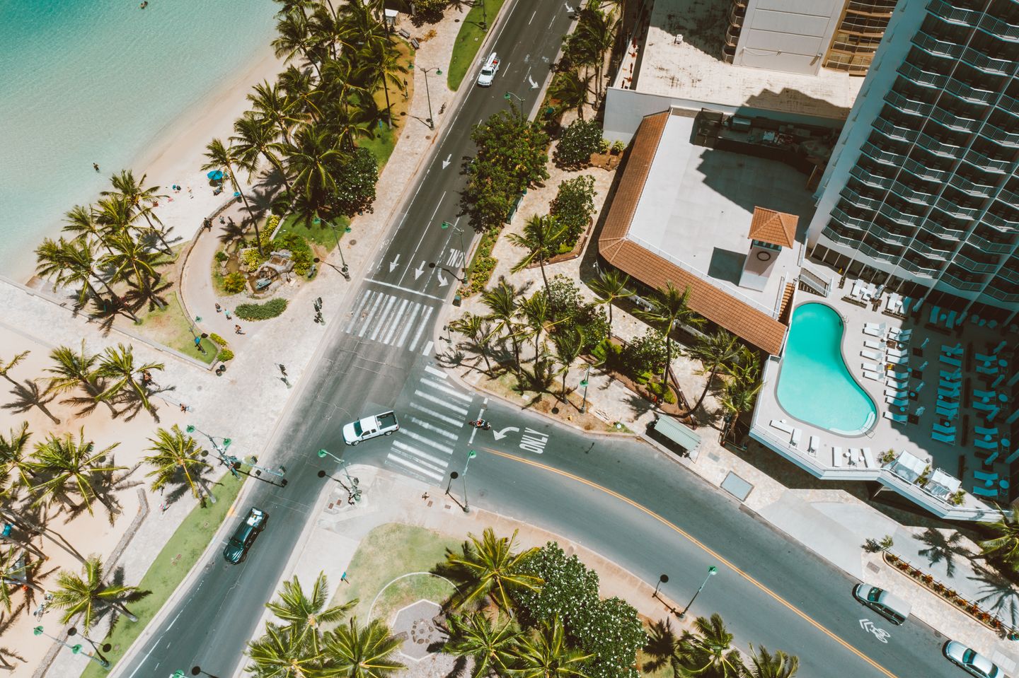 A resort pool deck looking out over the ocean on a Hawaiian coast