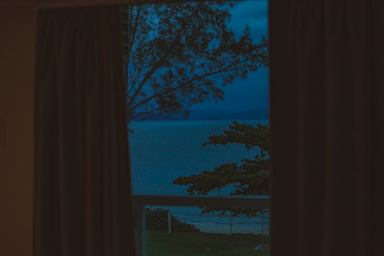 From Balcony View Of Night Sea With Mountains