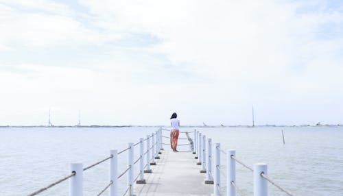 Free Woman Standing on Dock Stock Photo