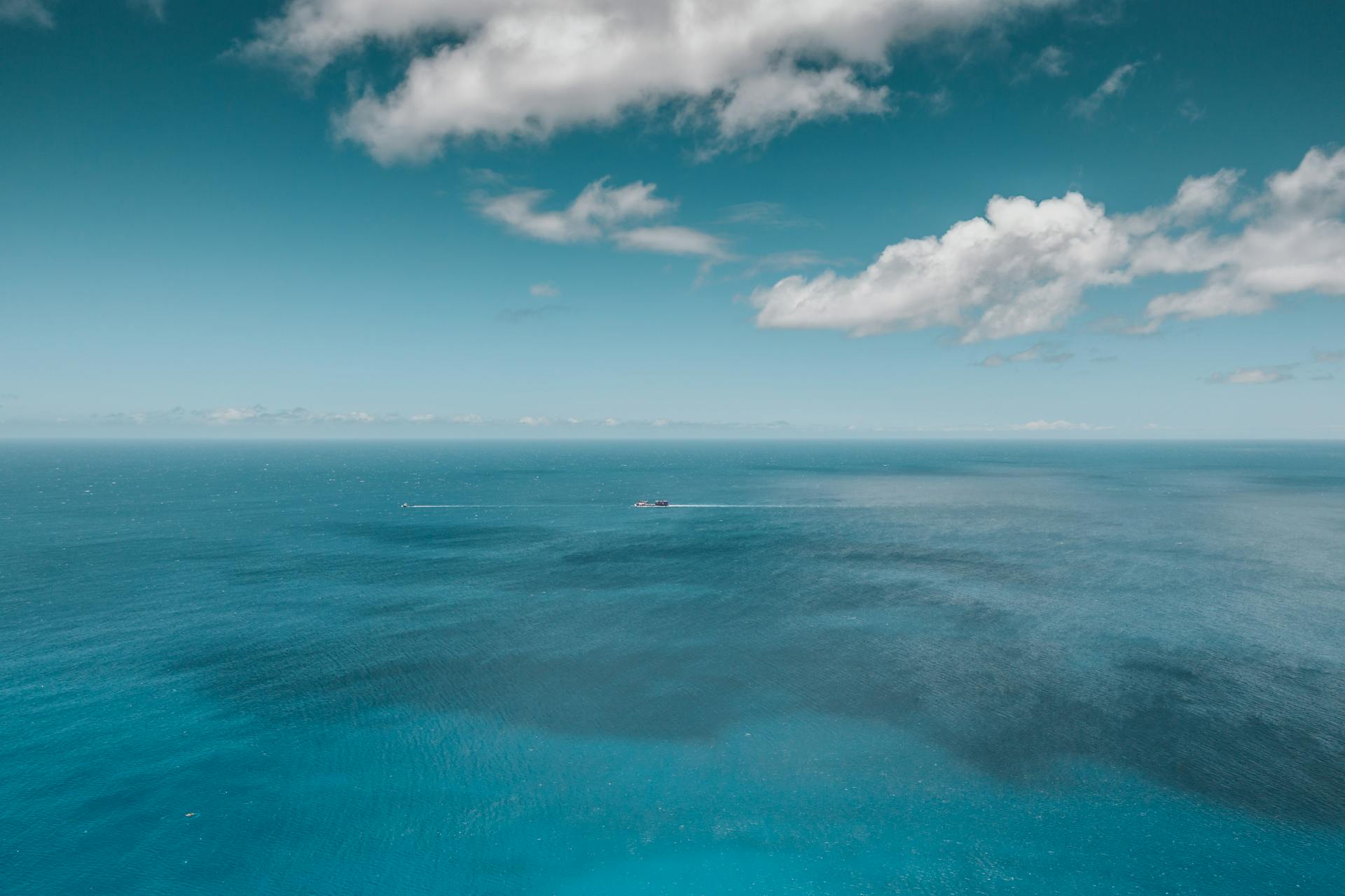 Blue Sea Under Blue Sky and White Clouds