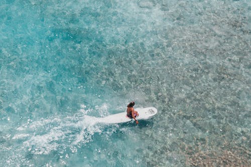 Man in Blue Shorts Surfing on Sea Waves