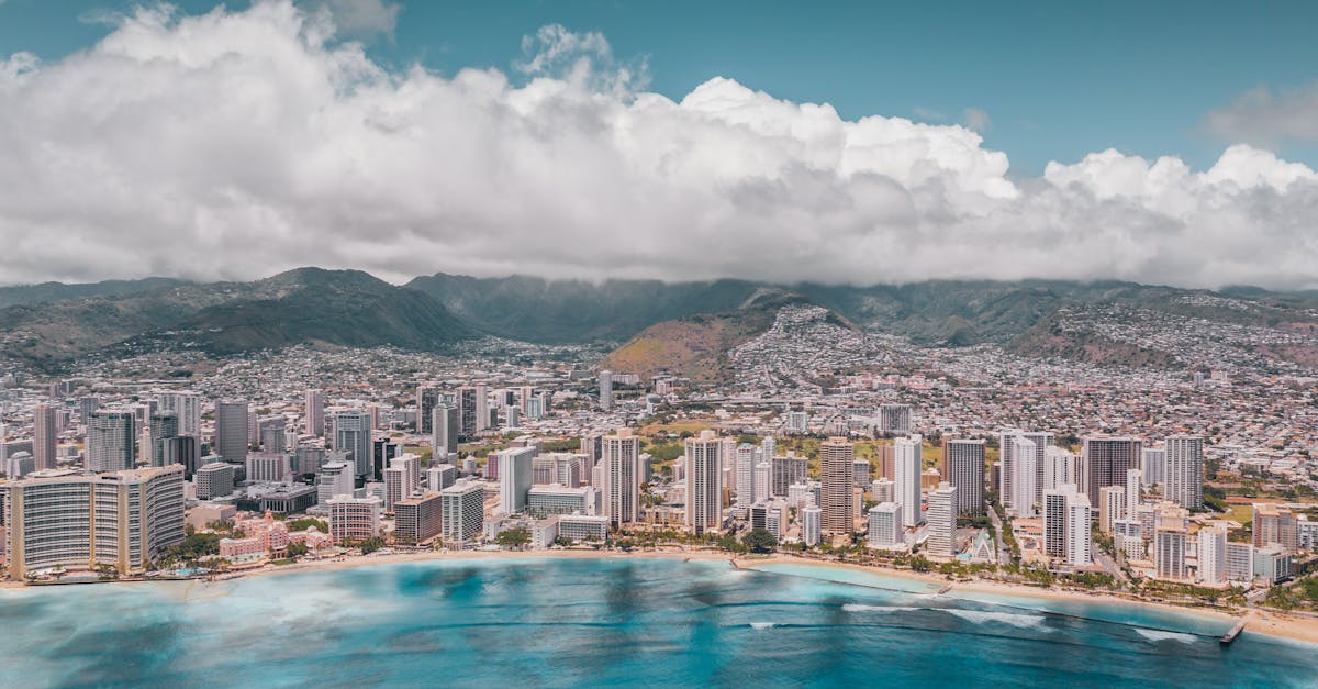 Photo by Jess Loiterton Stunning aerial view of Waikiki Beach with Honolulu's skyline and the Pacific Ocean.