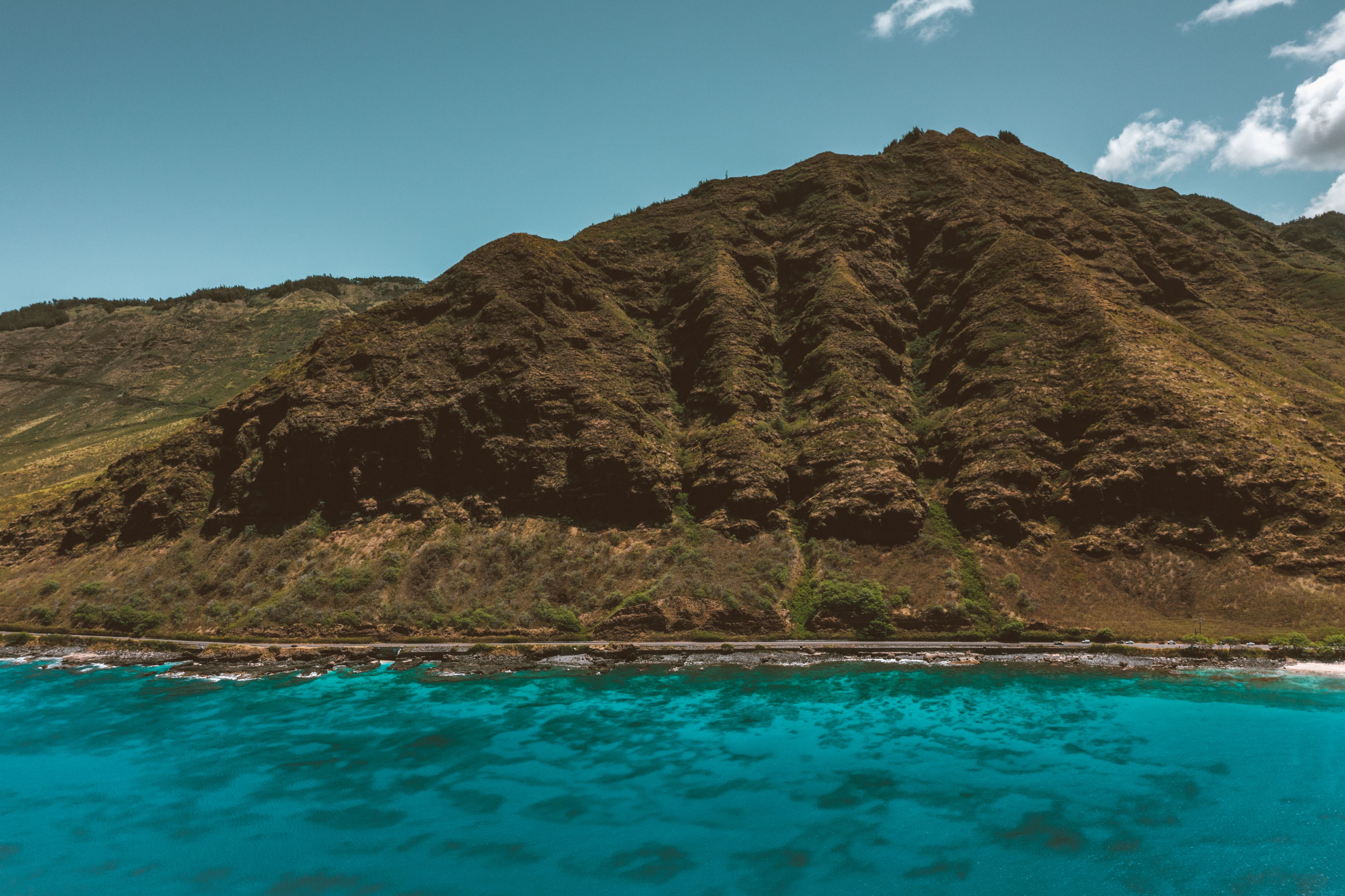 Breathtaking view of Hawaii's coastline with vibrant blue sea and lush mountains. Breathtaking view of Hawaii's coastline with vibrant blue sea and lush mountains.