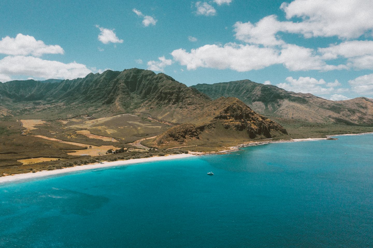 Aerial perspective across a Hawaiian island coastline and open ocean