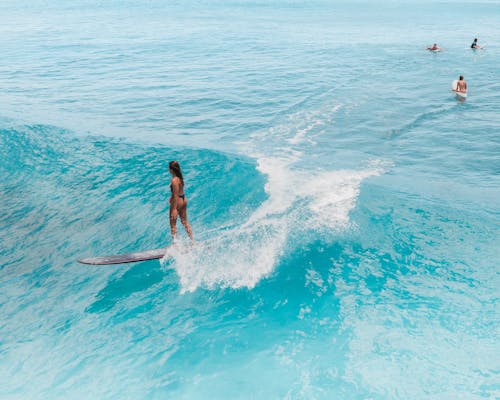 Man Surfing on Blue Sea