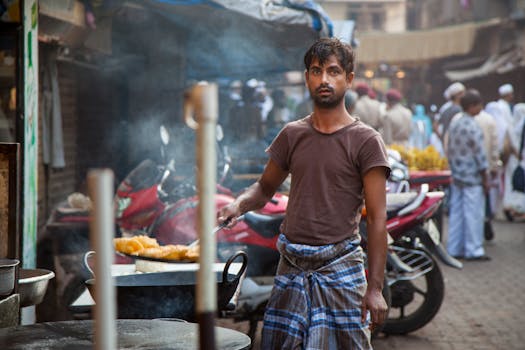 A street food vendor frying snacks in a busy Mumbai market, showcasing vibrant street life.