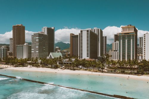 Free Vibrant view of Waikiki Beach with Honolulu's skyline and turquoise waters of Hawaii. Stock Photo