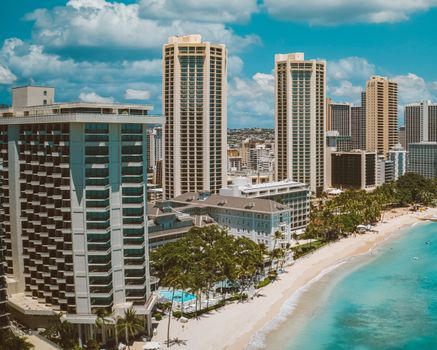 Photo by Jess Loiterton Breathtaking aerial view of Waikiki Beach with luxury hotels and clear blue waters.