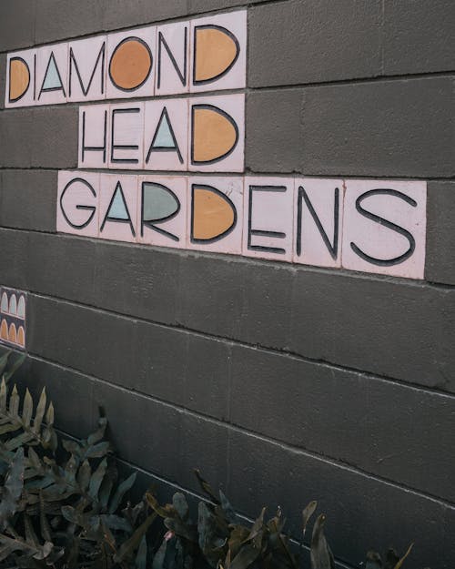 Diamond Head Gardens Text on Gray Wall
