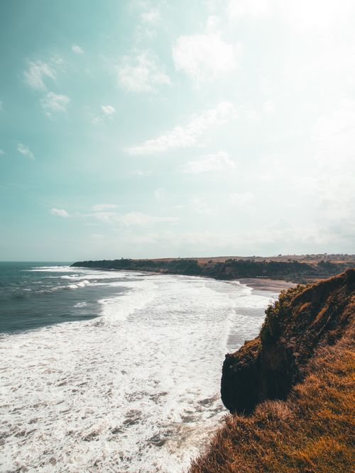Free Breathtaking view of West Java coast with waves crashing against cliffs under a bright sky. Stock Photo