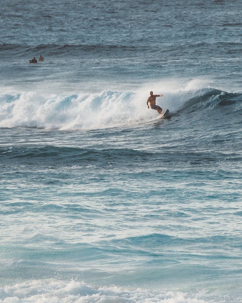 Shirtless Man Surfing Sea Waves