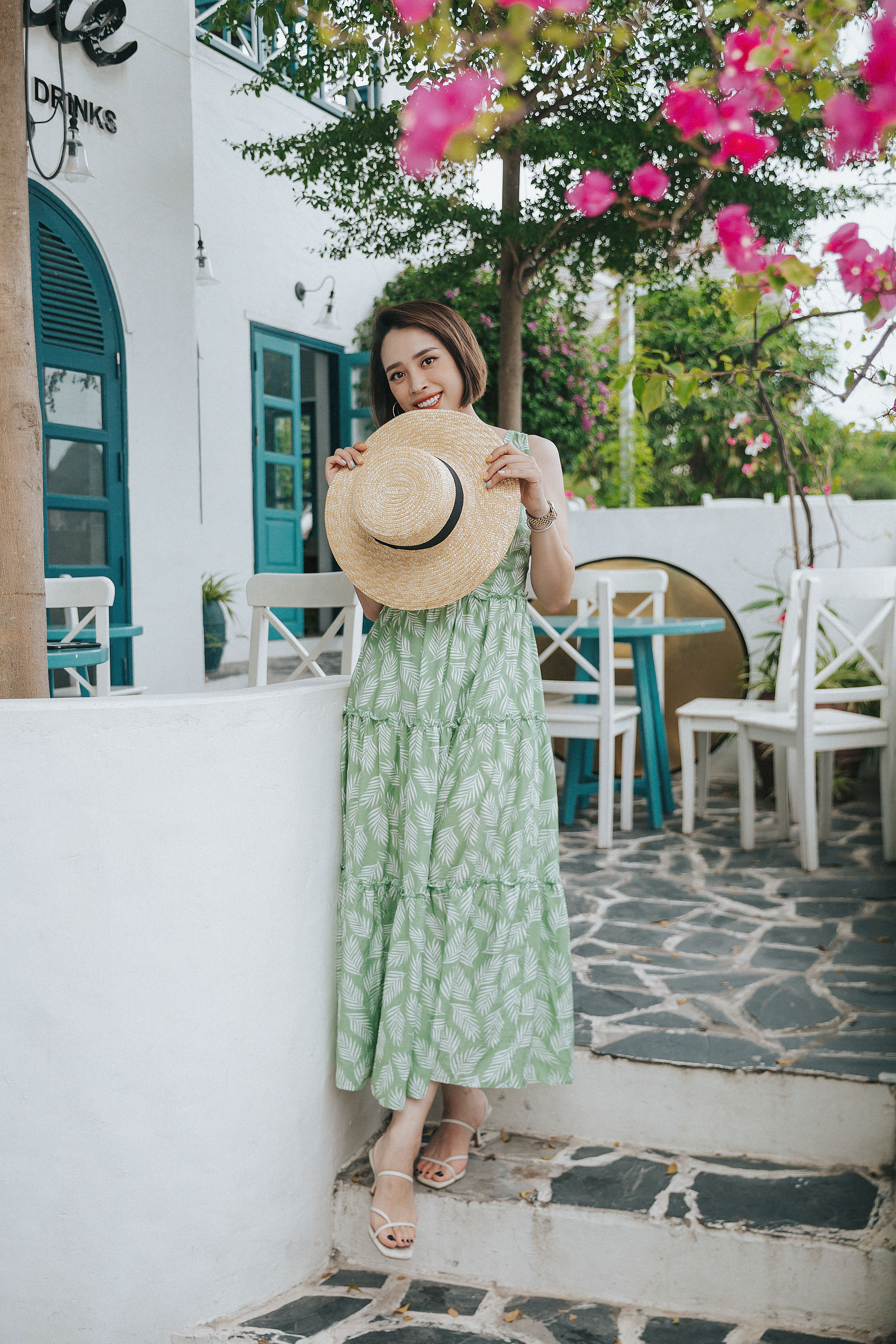 stylish sundress and straw hat outdoors 