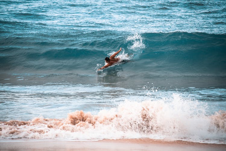 A Man Swimming In The Ocean