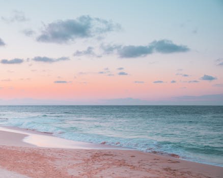 Captivating pink and blue hues at a serene Honolulu beach during sunset.