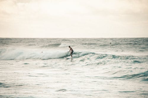 Man Surfing on Ocean Waves