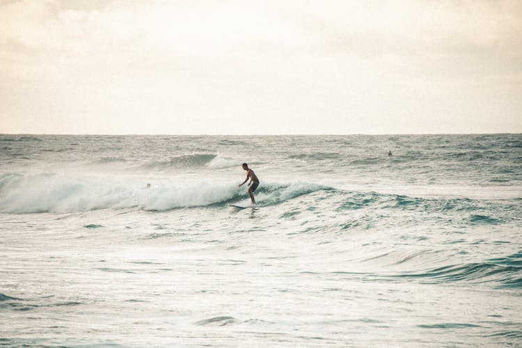 Man Surfing On Ocean Waves