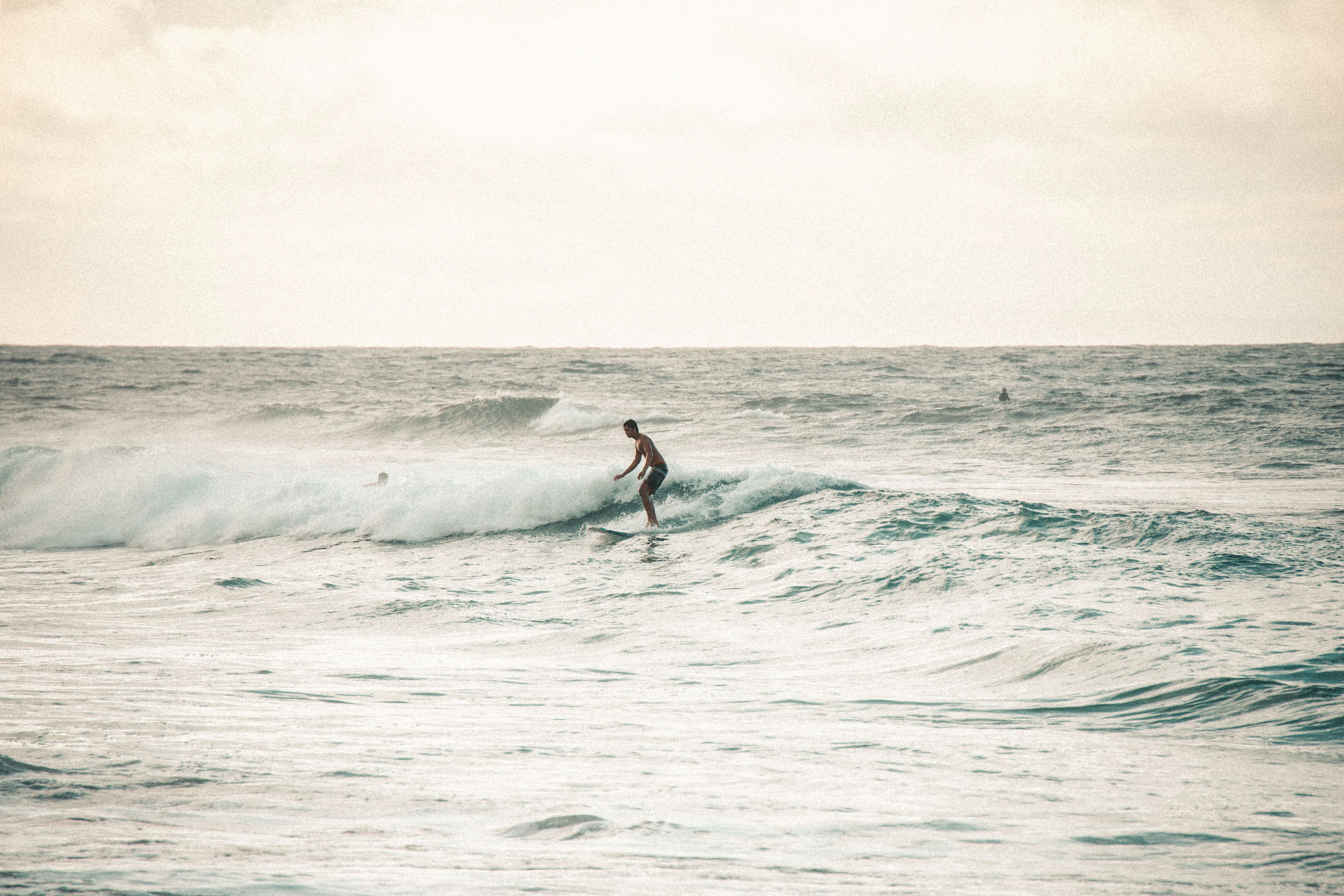 A Man in White Wet Suit Surfing on Sea Waves with a Kite Board · Free ...