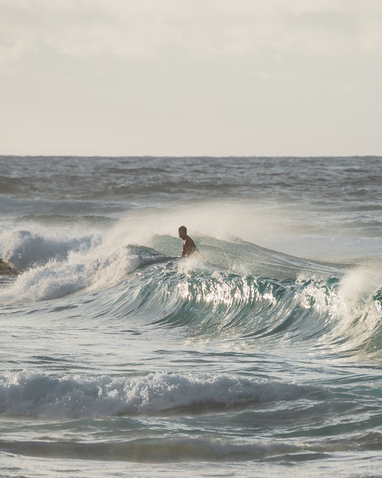 Person Swimming On Sea Waves