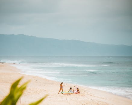 Three people enjoying a relaxing day on the sandy beaches of Pupukea, Hawaii.