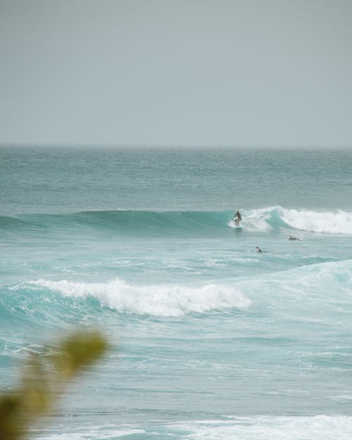 Person Surfing on Sea Waves