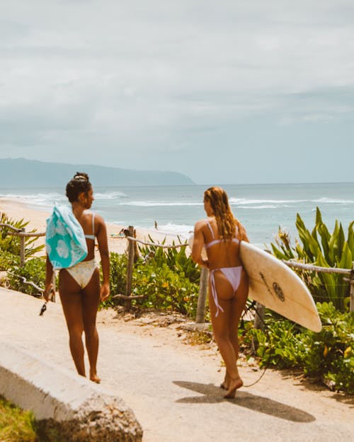 Women in Bikini Standing on Beach Shore