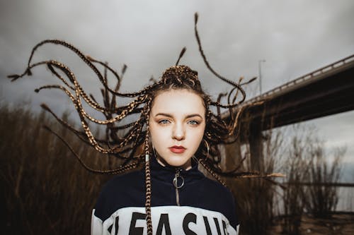 Photo of Woman Wearing Dreadlocks with Hair Flying 
