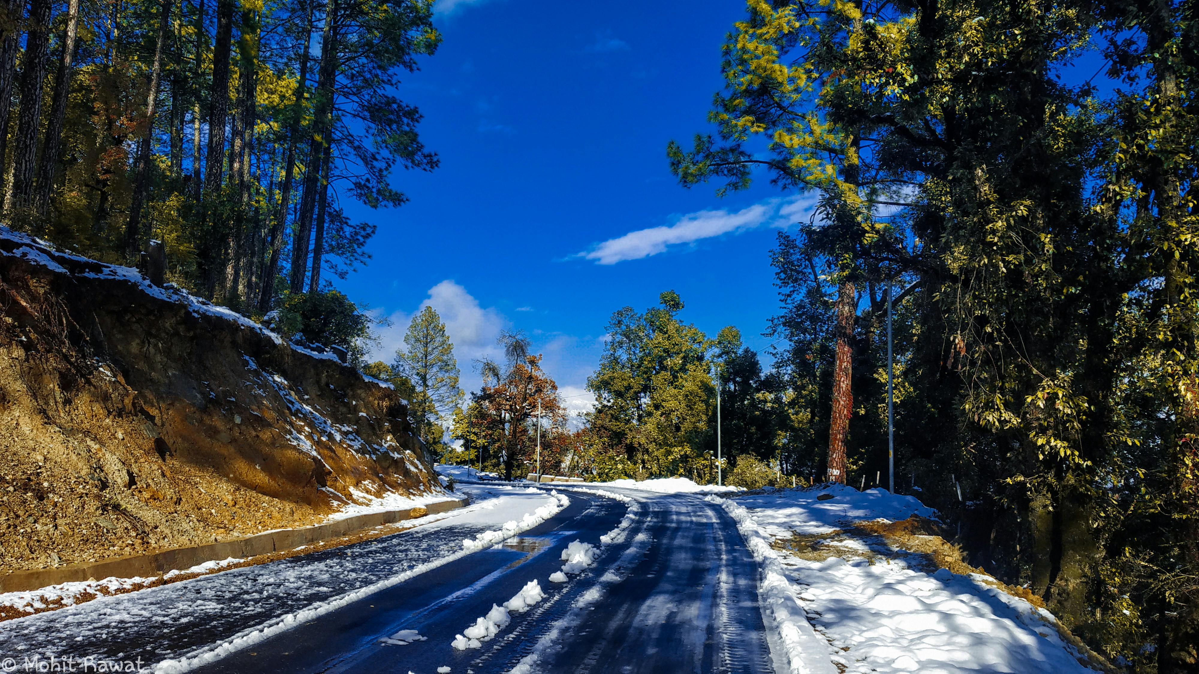 Woman covering her ears with a pillow while her partner snores loudly in bed
