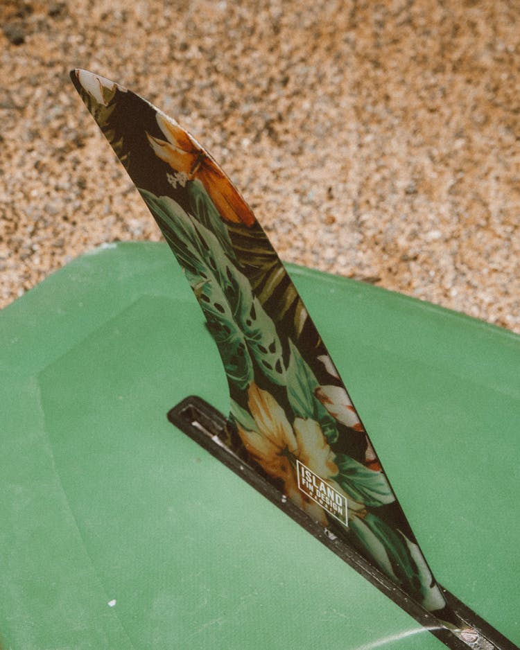 Green Surfboard With Floral Design On Fin