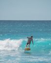 Man in Black Wetsuit Surfing on Sea Waves