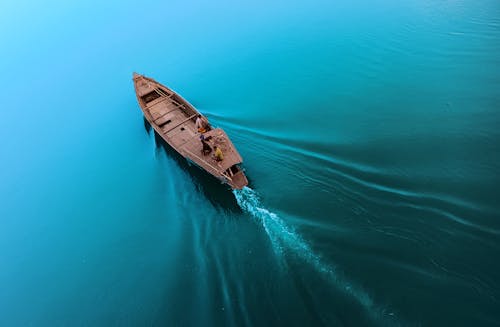 Boat floating on calm blue seawater