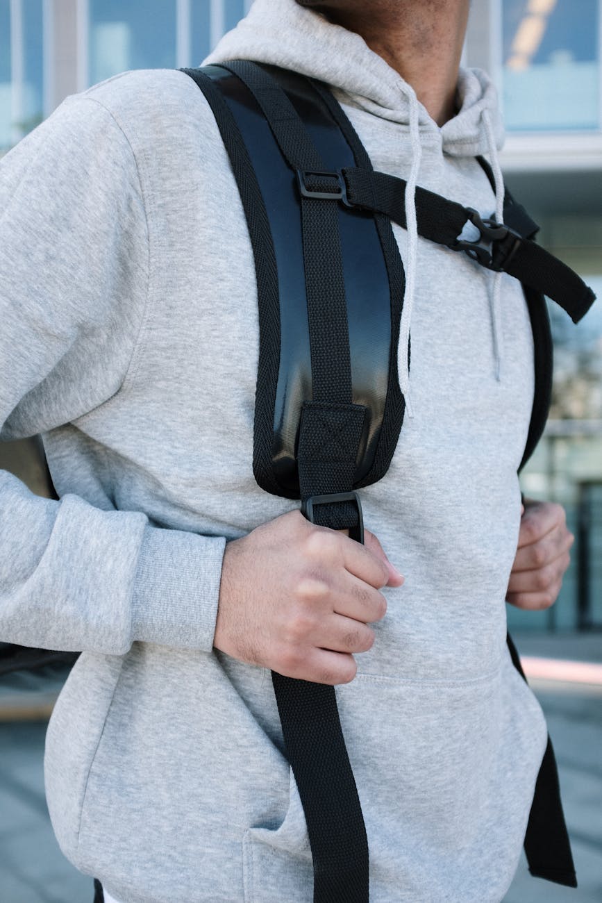 Close-up of a man with a camera backpack outside