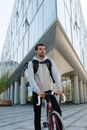 Man in Black and White Jacket Riding on Bicycle